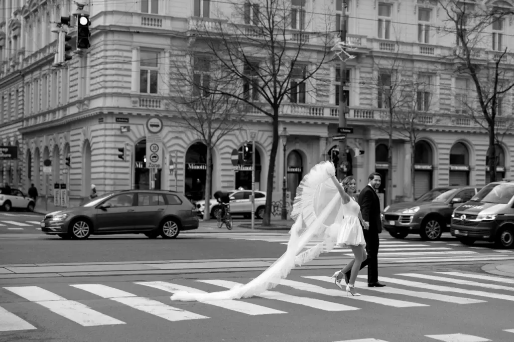 Hochzeitspaar überquert Straße in Wien und Hochzeitsfotograf Wien Sandy Alonso fängt den Moment ein